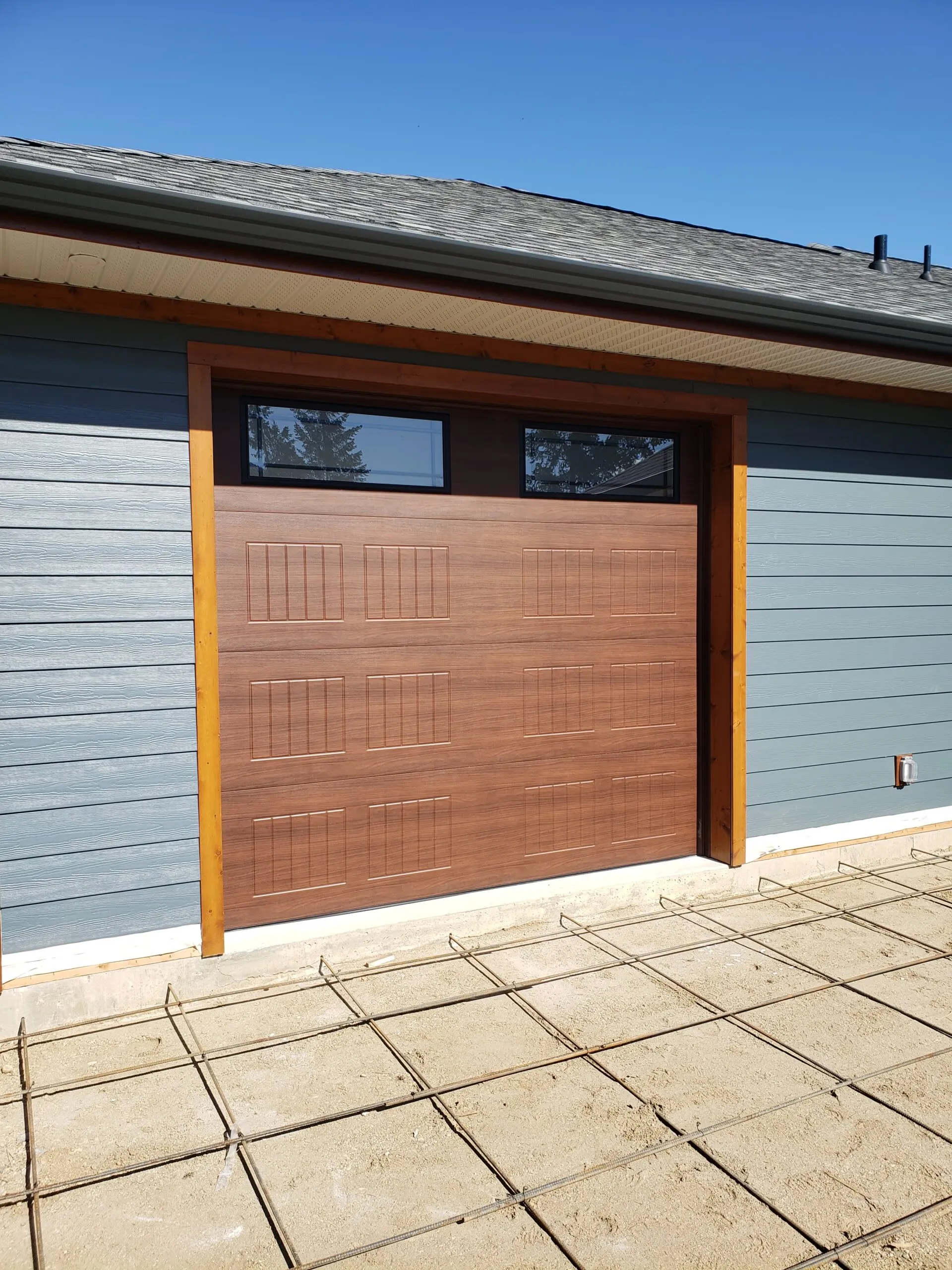 Carriagecraft carriage-house garage door in walnut woodgrain