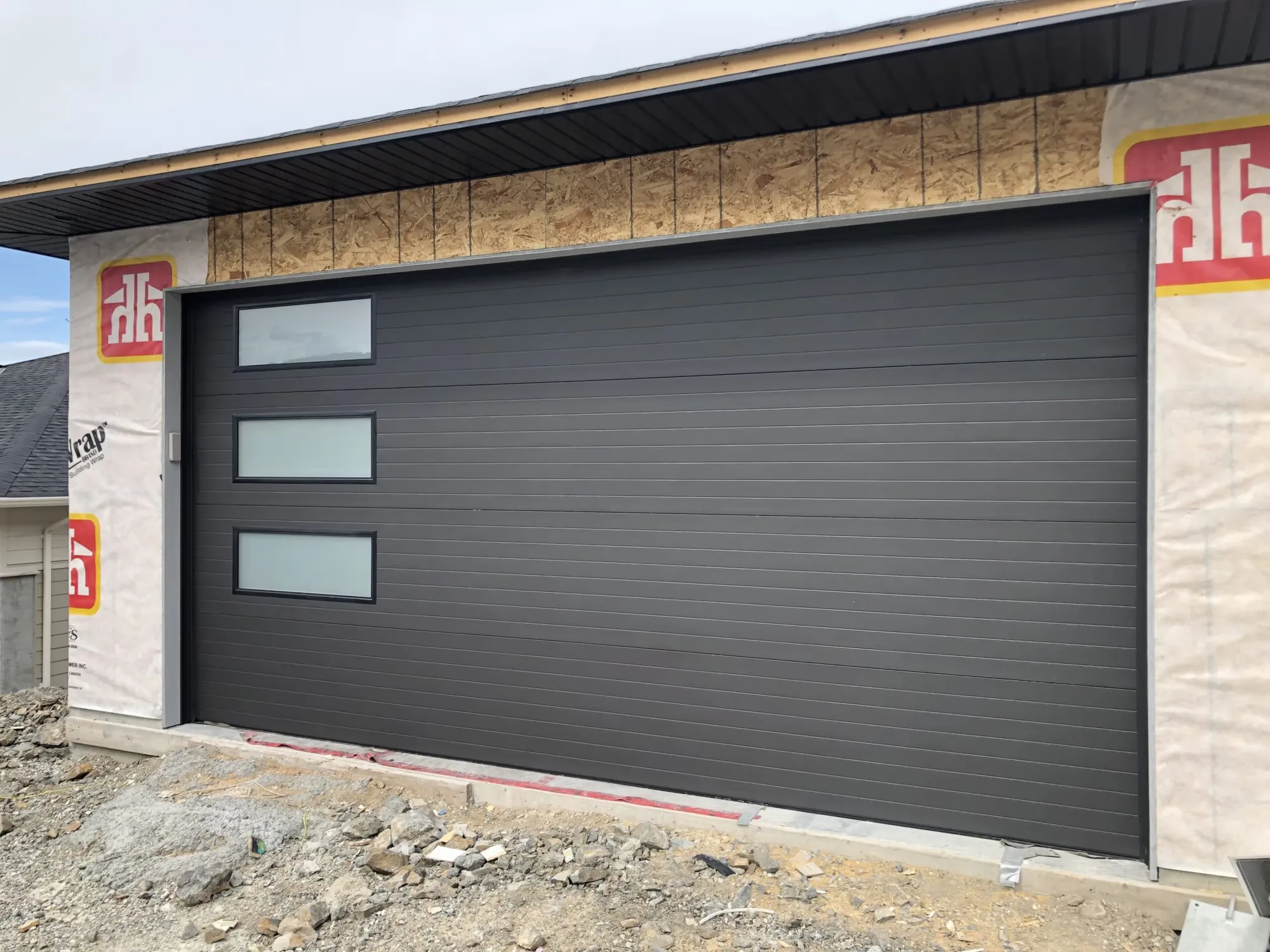 Contemporary charcoal garage door with a stacked full-view glass top section