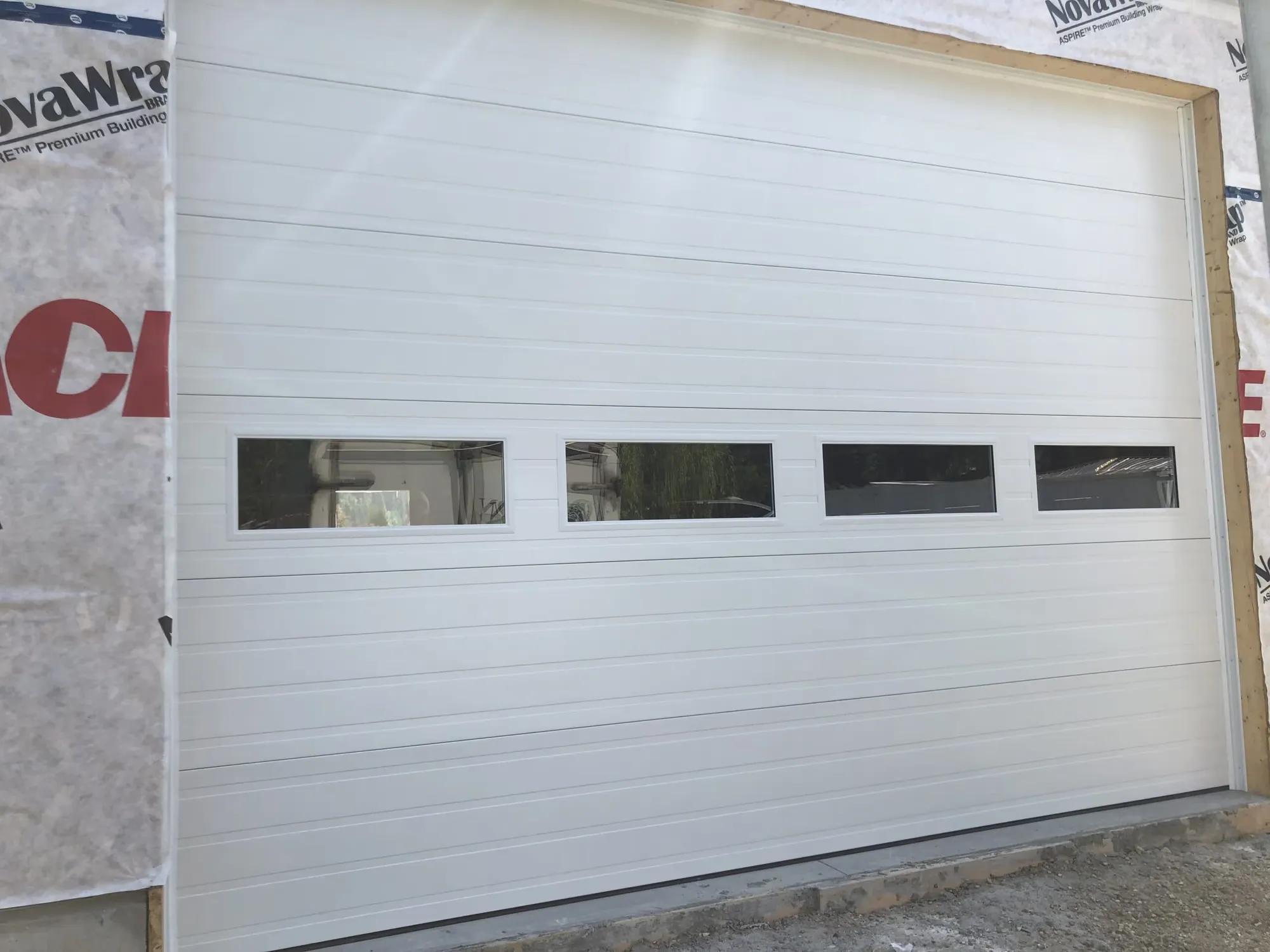 Commercial storefront-style sectional door with full glass panels