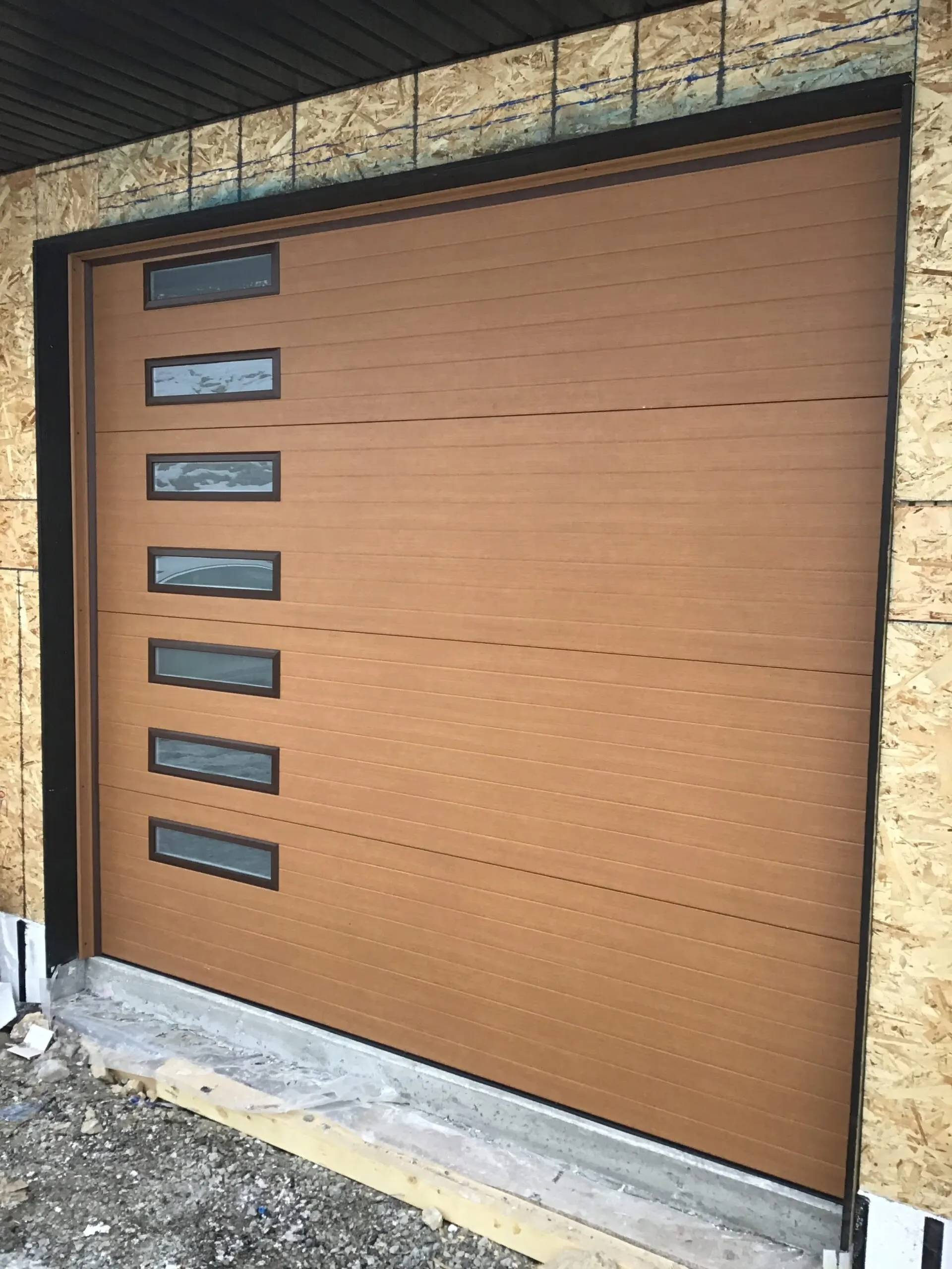 Contemporary natural cedar garage door as a statement facade