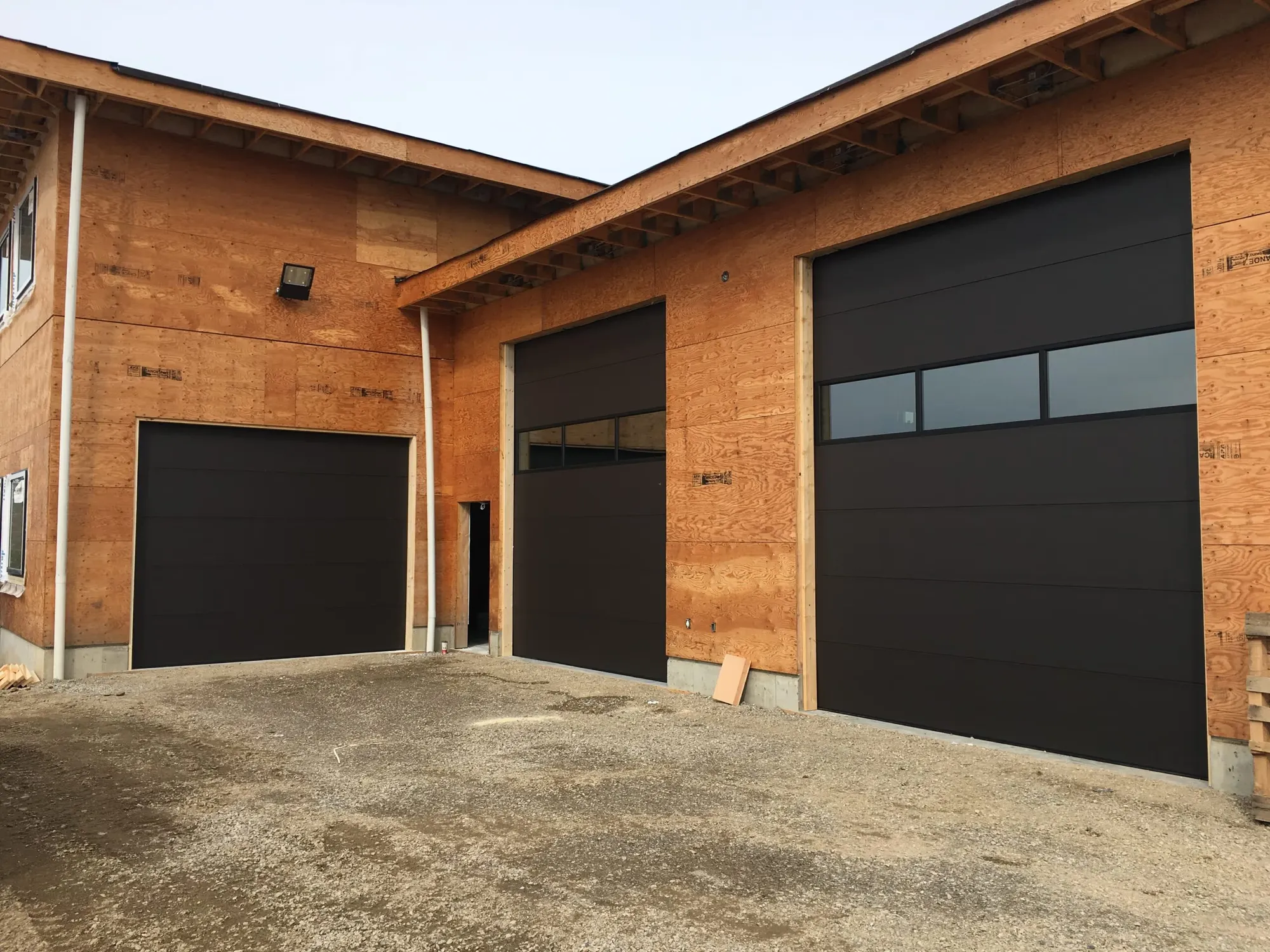 Charcoal flush garage door with full-view aluminum and frosted glass panels