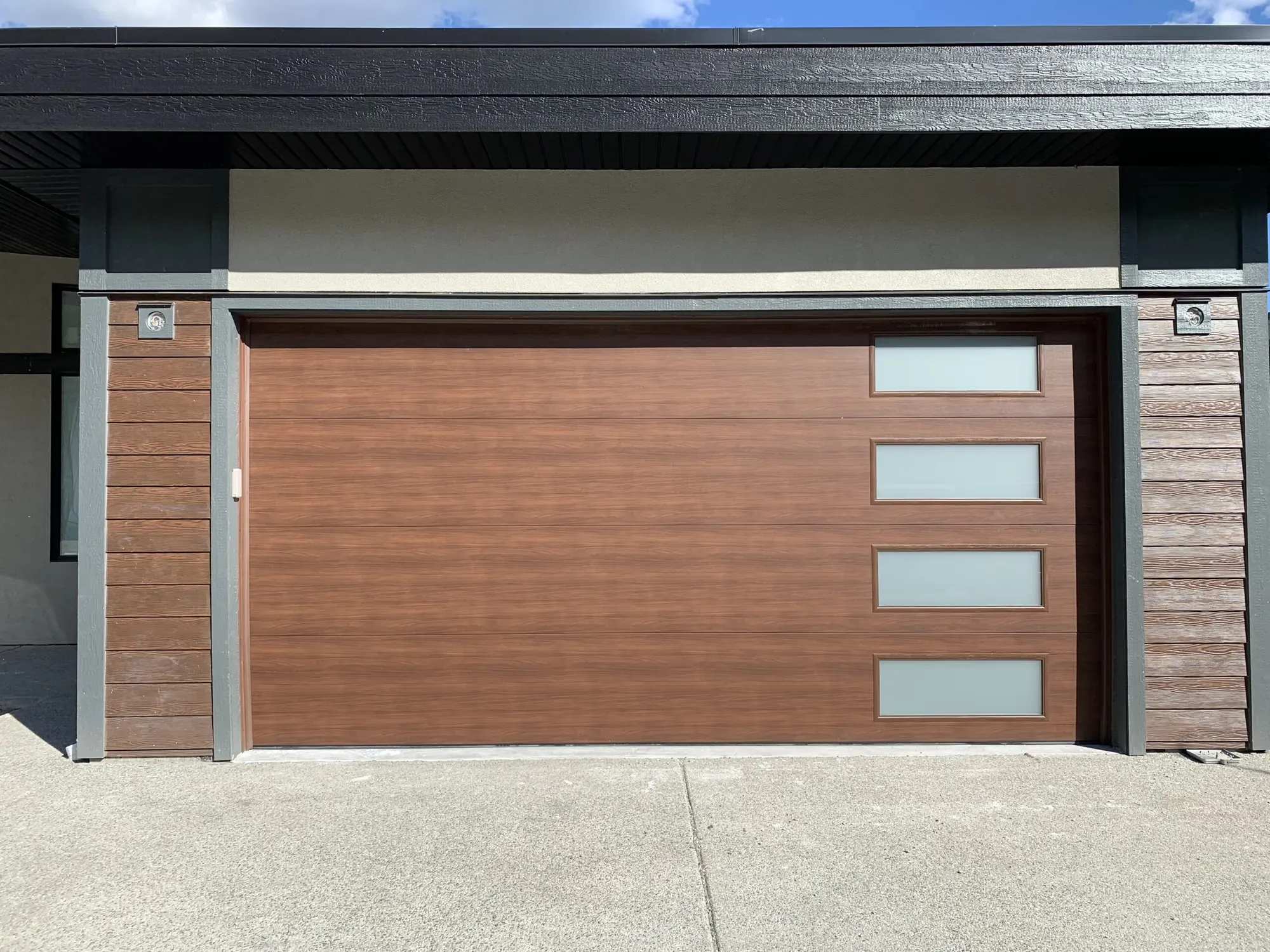 Clean-lined flush garage door in walnut woodgrain