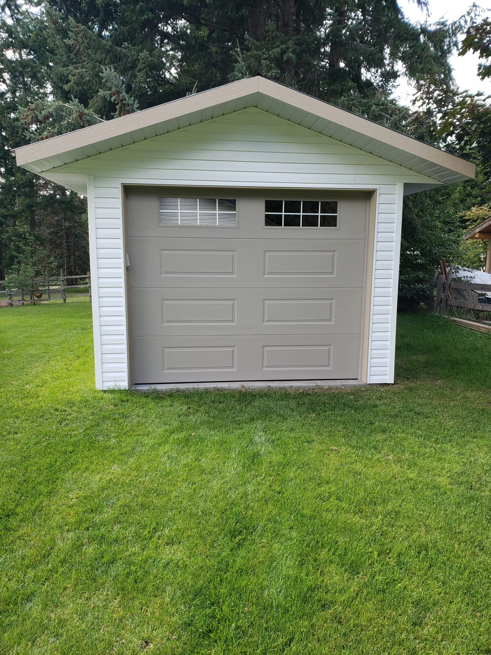 Ranchcraft carriage-style garage door in warm sandstone
