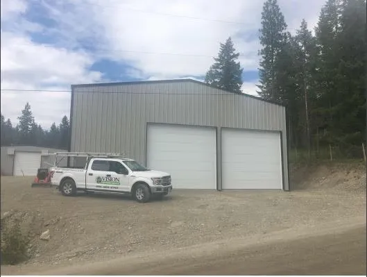 Vision Overhead Doors service truck parked outside a garage in the Okanagan
